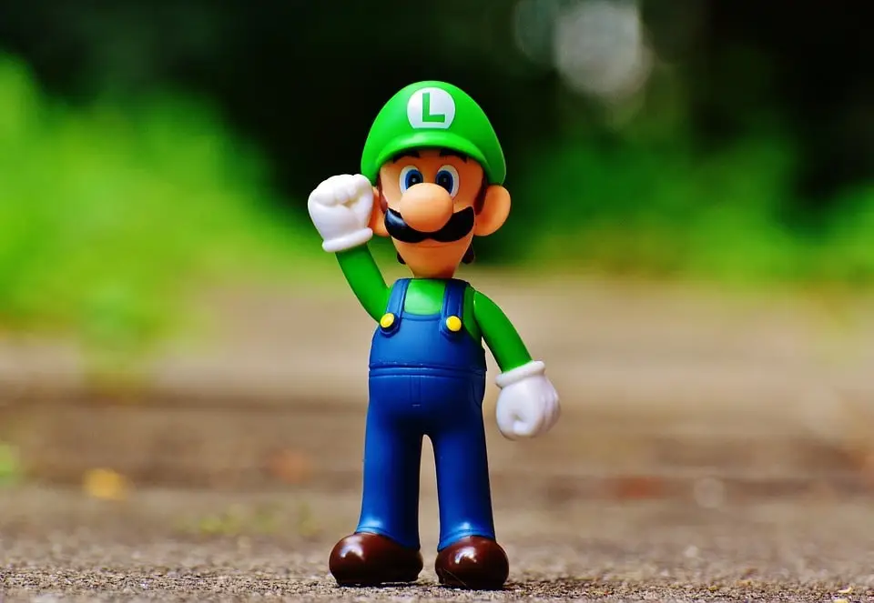 Statuetta Luigi, personaggio dei videogiochi, su sfondo sfocato.